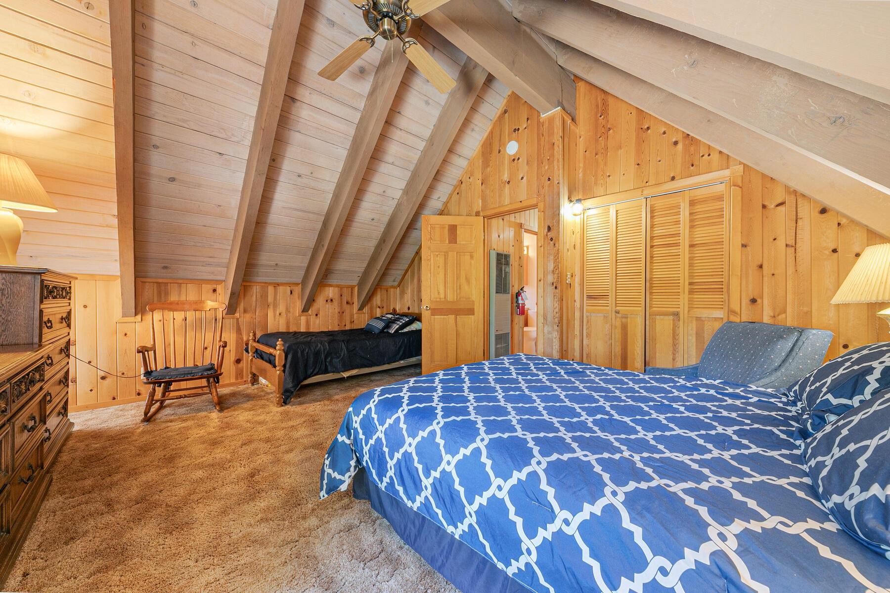 5775 Victoria Drive Carnelian Bay, CA 96140 - Photo 23 of 28 a bedroom with a bed and wooden floor