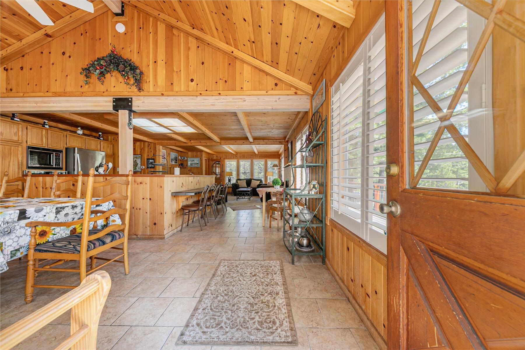5775 Victoria Drive Carnelian Bay, CA 96140 - Photo 5 of 28 a view of a patio with dining table and chairs with wooden floor