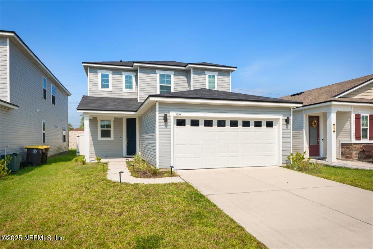 7194 Red Timber Road Jacksonville, FL 32244 - Photo 13 of 40 a front view of a house with a yard and garage