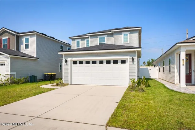 a view of an empty room with stairs and a window