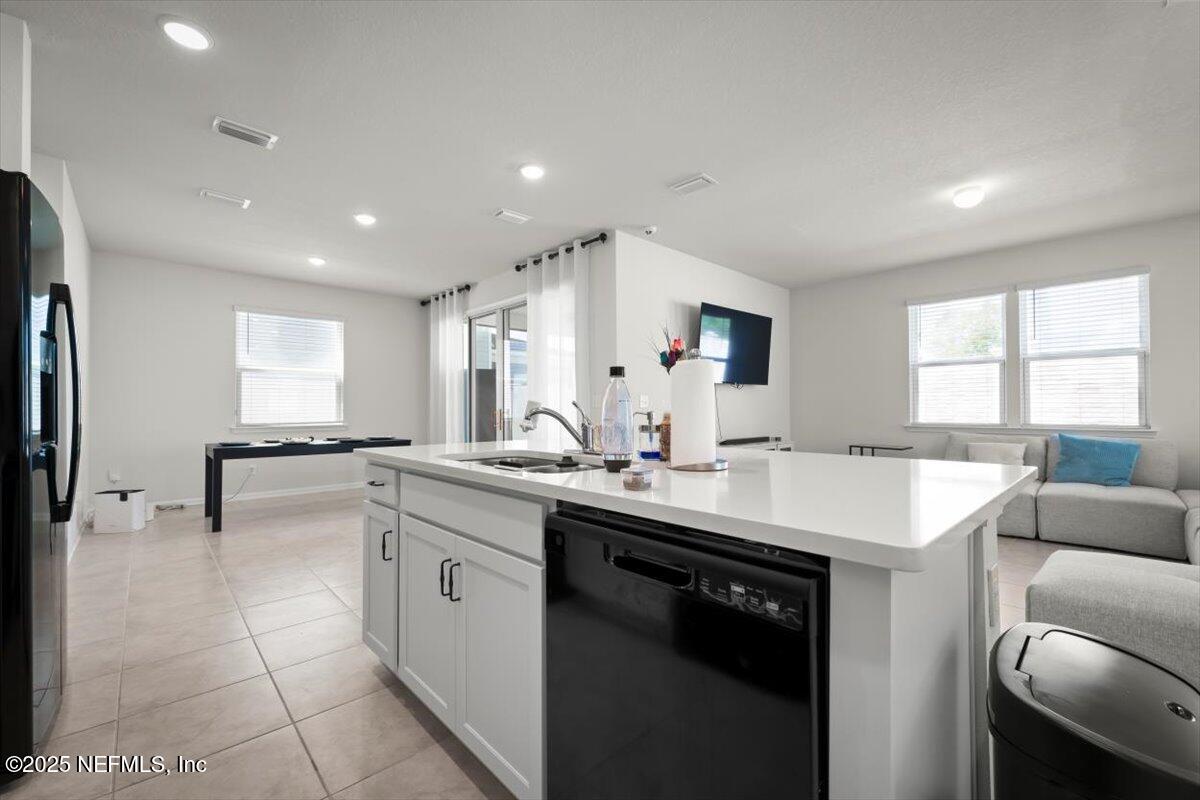 7194 Red Timber Road Jacksonville, FL 32244 - Photo 20 of 40 a kitchen with a sink a stove a refrigerator and cabinets