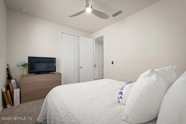 a bathroom with a toilet and a shower curtain