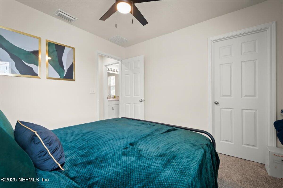 7194 Red Timber Road Jacksonville, FL 32244 - Photo 27 of 40 a room with a bed and a painting on the wall