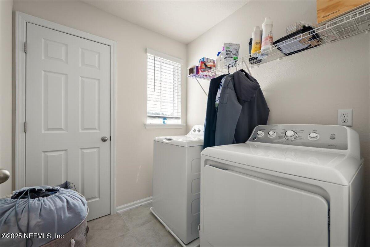7194 Red Timber Road Jacksonville, FL 32244 - Photo 28 of 40 a view of washer and dryer with bathroom in the background