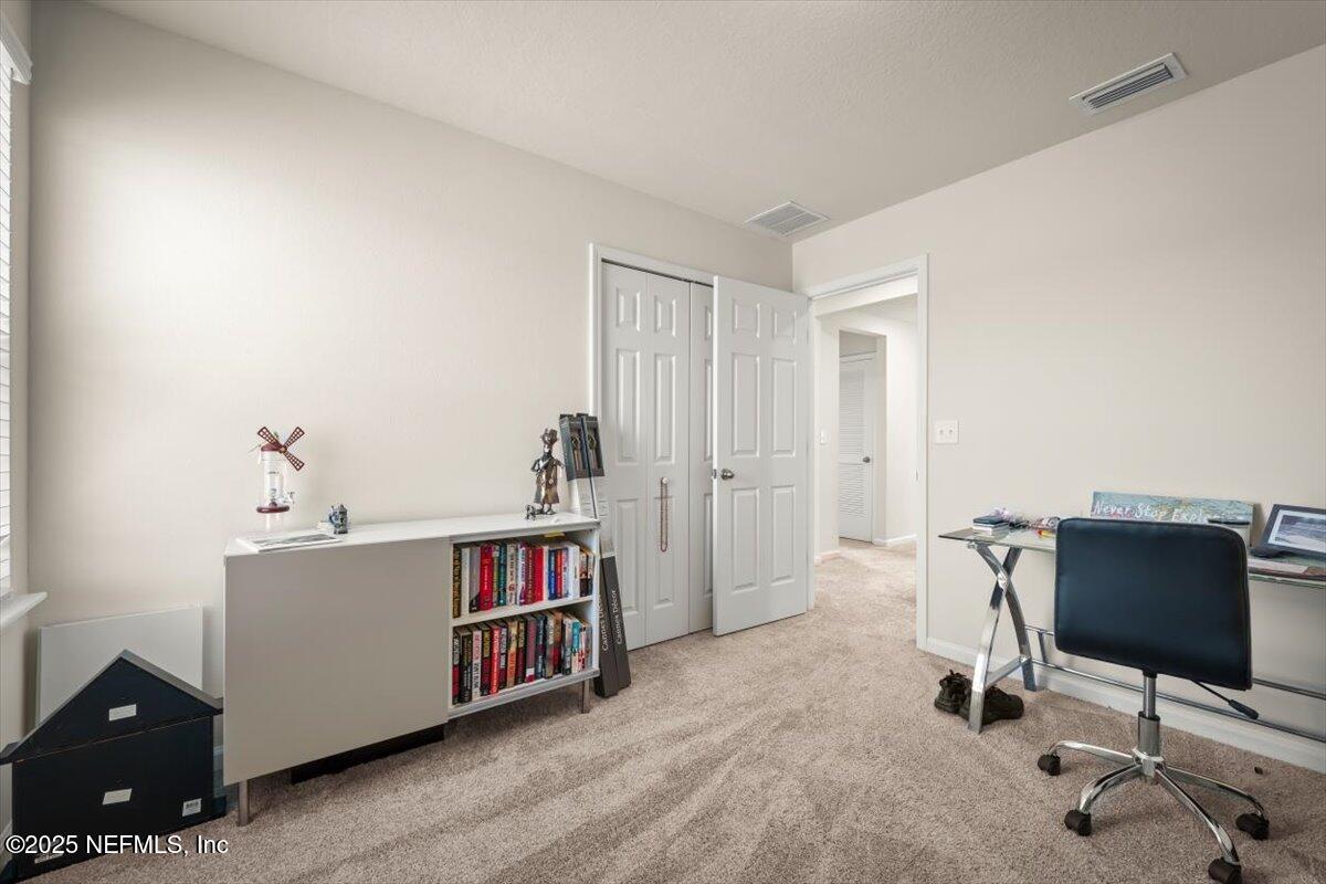 7194 Red Timber Road Jacksonville, FL 32244 - Photo 29 of 40 a view of a workspace with furniture and a window