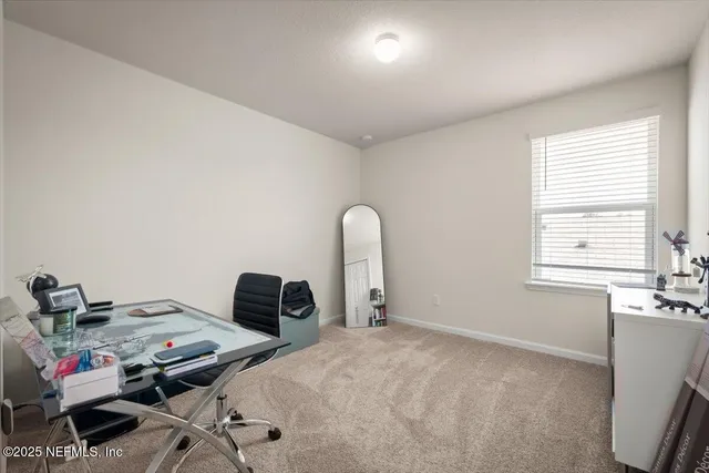 a bedroom with a bed a table and a window