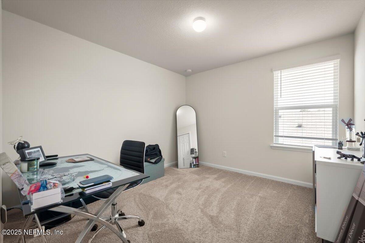 7194 Red Timber Road Jacksonville, FL 32244 - Photo 30 of 40 a bedroom with a bed and a window