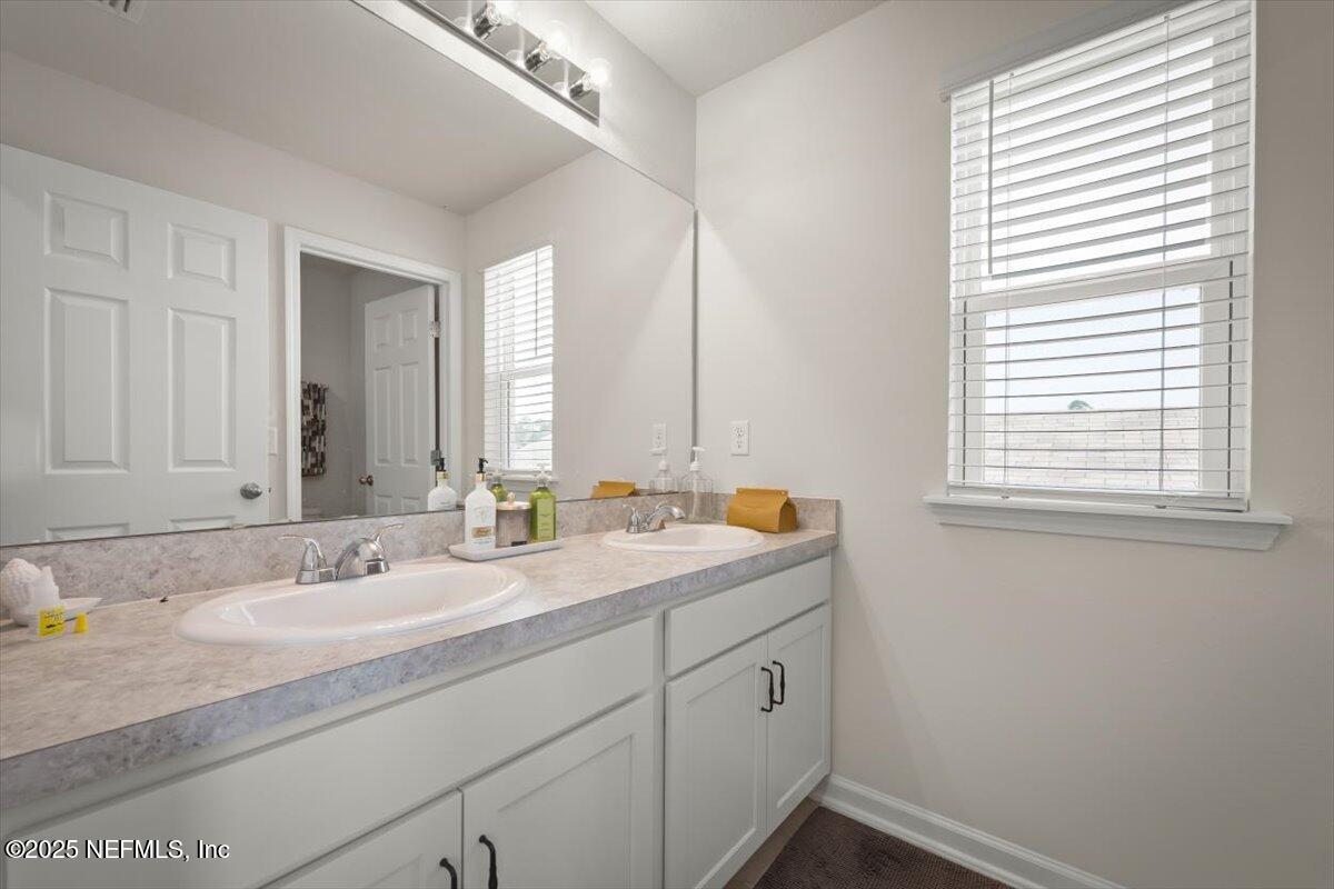 7194 Red Timber Road Jacksonville, FL 32244 - Photo 31 of 40 a bathroom with a sink and a window