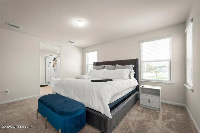 a bathroom with a double vanity sink and mirror with window