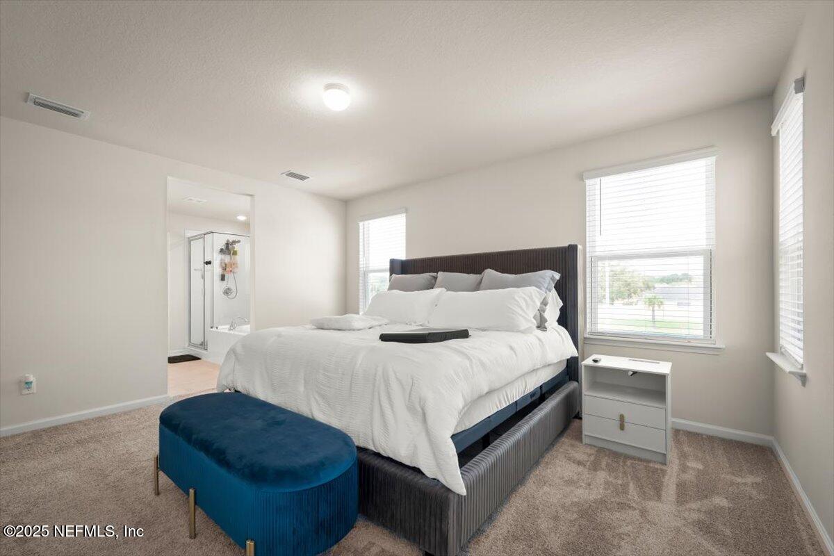 7194 Red Timber Road Jacksonville, FL 32244 - Photo 33 of 40 a bed room with a bed and a window