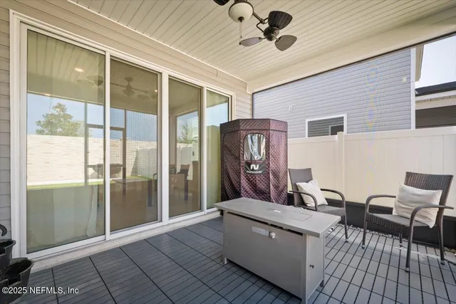 a backyard of a house with table and chairs