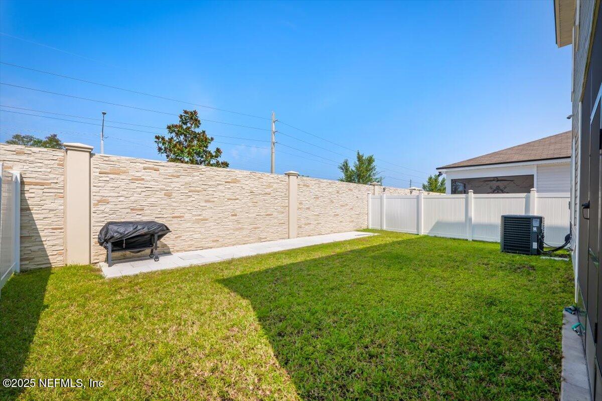 7194 Red Timber Road Jacksonville, FL 32244 - Photo 40 of 40 a backyard of a house with table and chairs