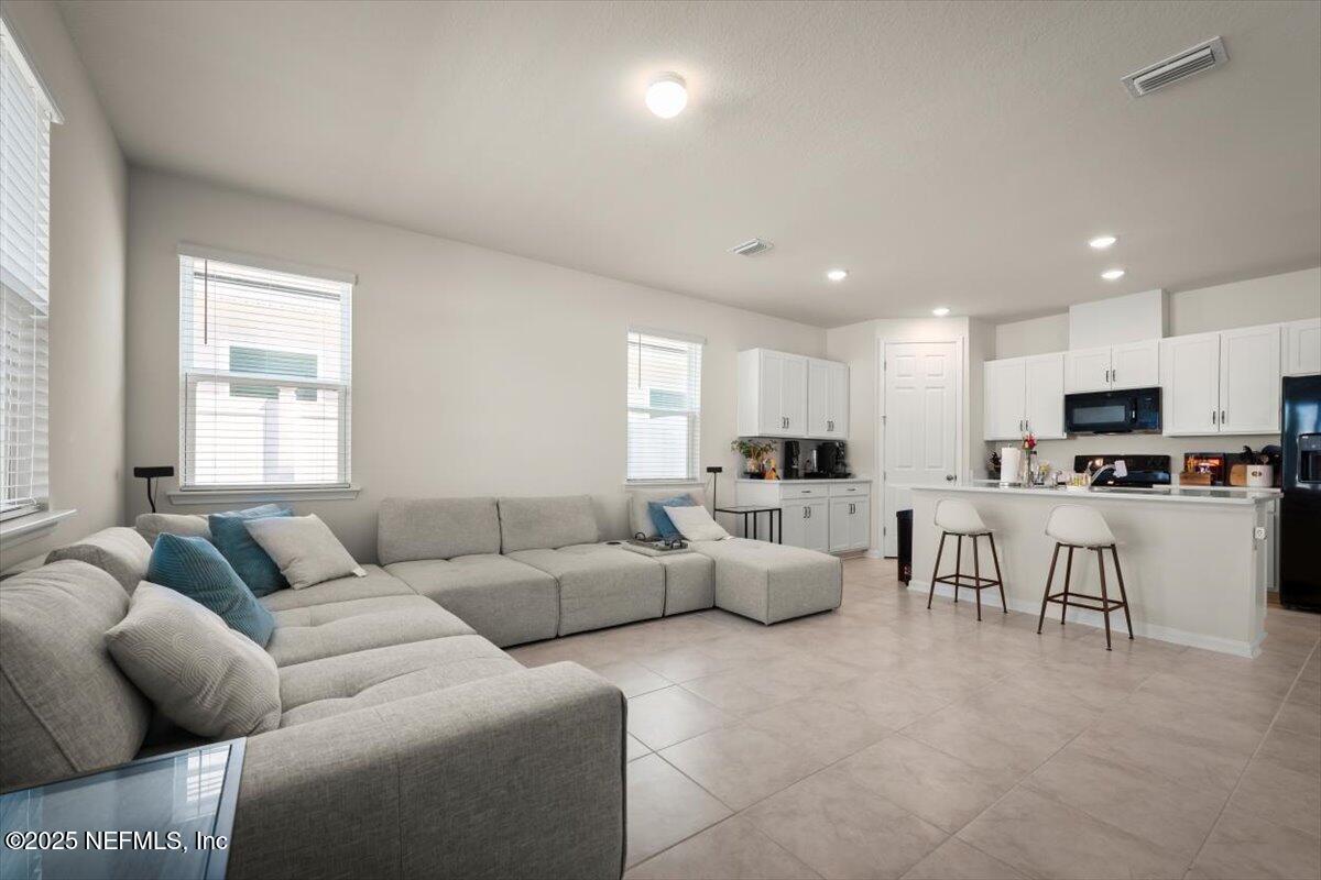 7194 Red Timber Road Jacksonville, FL 32244 - Photo 4 of 40 a living room with furniture and kitchen view