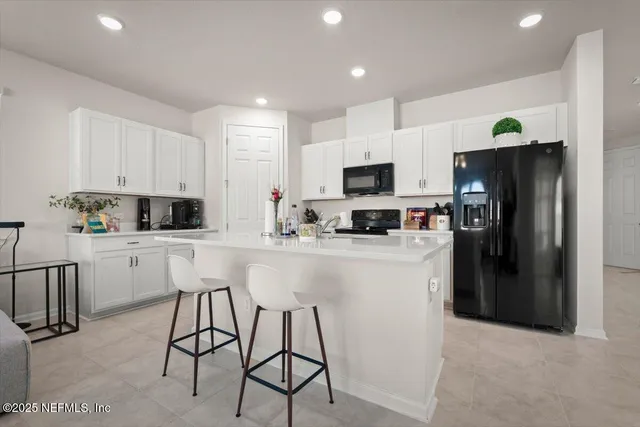 a kitchen with cabinets a sink and stainless steel appliances