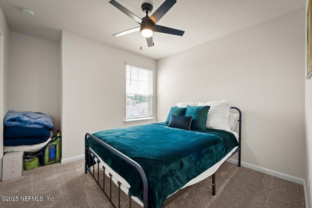 7194 Red Timber Road Jacksonville, FL 32244 - Photo 8 of 40 a bedroom with a bed and a window