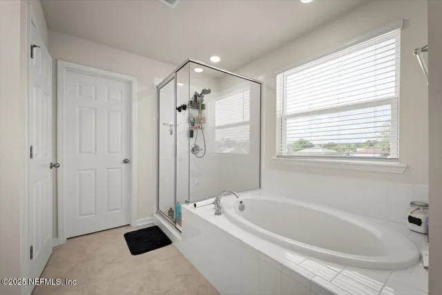 a bathroom with a bathtub and shower