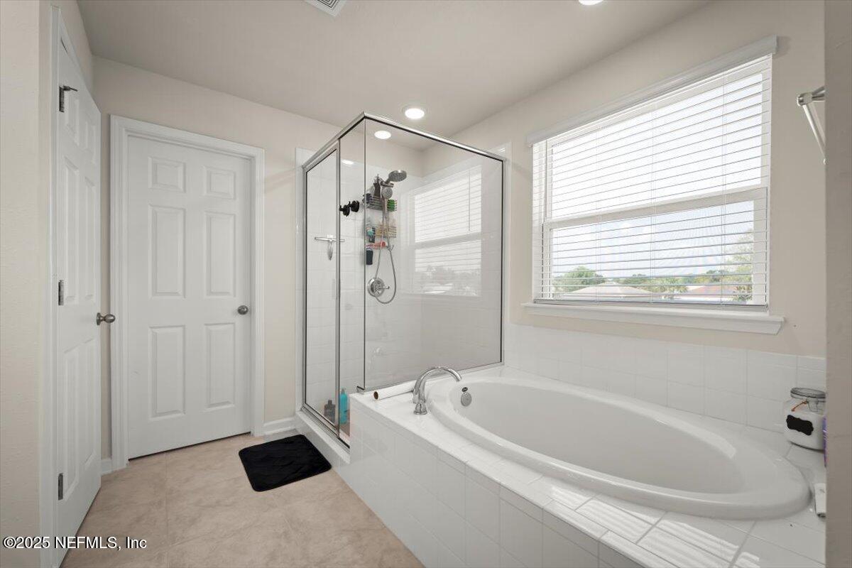 7194 Red Timber Road Jacksonville, FL 32244 - Photo 9 of 40 a bathroom with a bathtub and shower