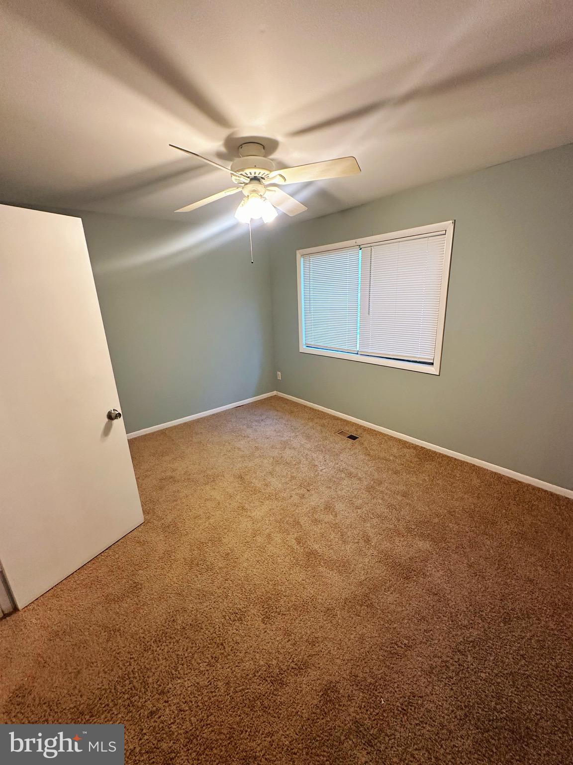 807 C Windstream Way, Unit 807C Edgewood, MD 21040 - Photo 10 of 11 a view of an empty room with window and chandelier fan