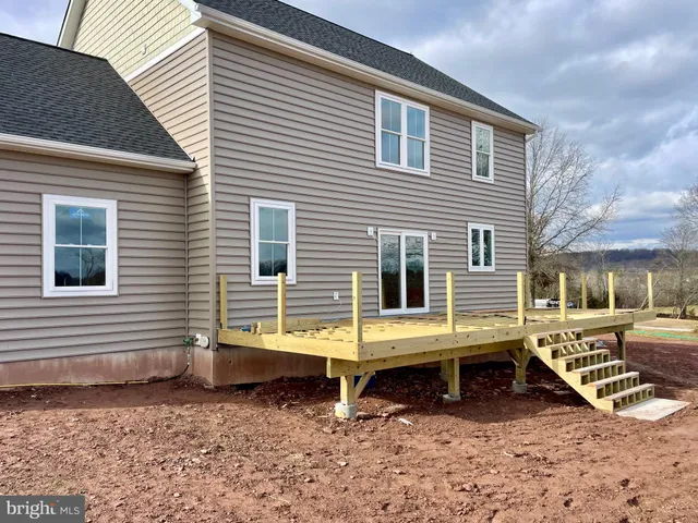 a view of a house with a yard and sitting area