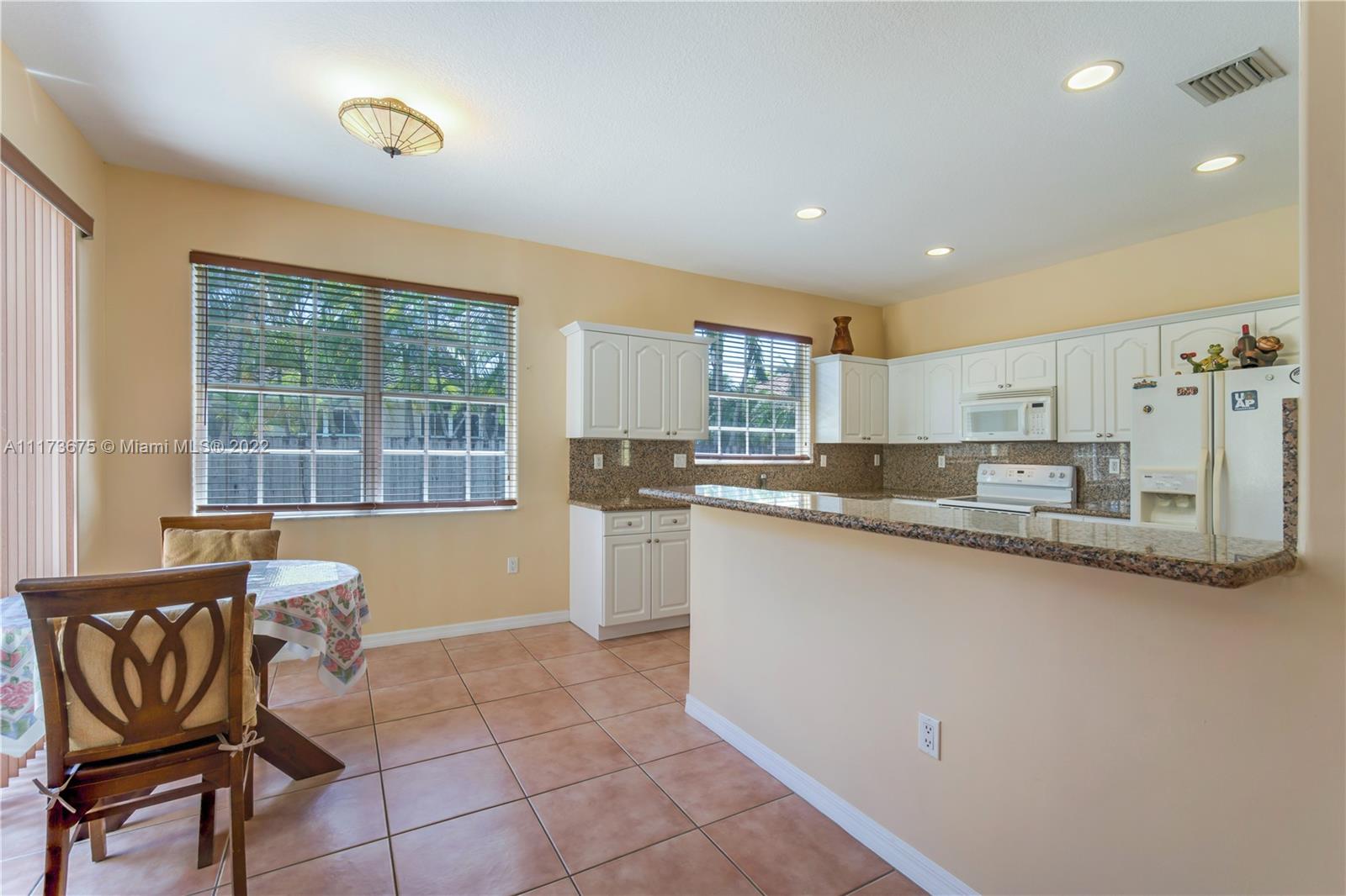 16234 Southwest 48th Terrace Miami, FL 33185 - Photo 15 of 45 a large kitchen with a counter space a sink and cabinets
