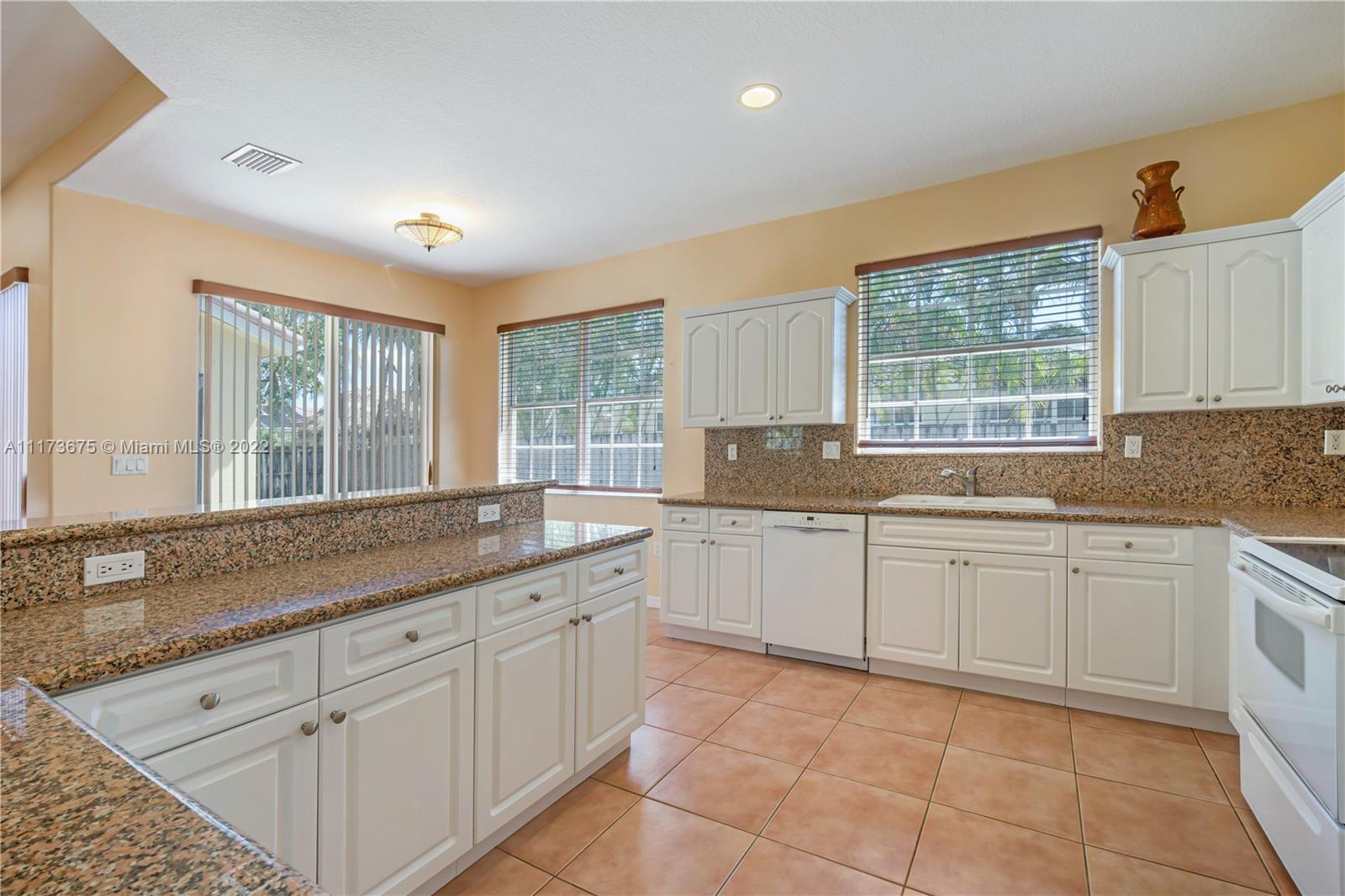 16234 Southwest 48th Terrace Miami, FL 33185 - Photo 18 of 45 a kitchen with a sink and cabinets