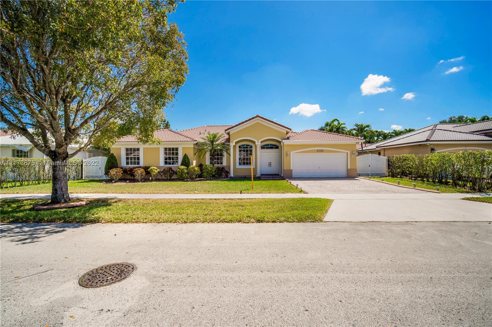 16234 Southwest 48th Terrace Miami, FL 33185 - Photo 2 of 45 a front view of a house with a yard and trees