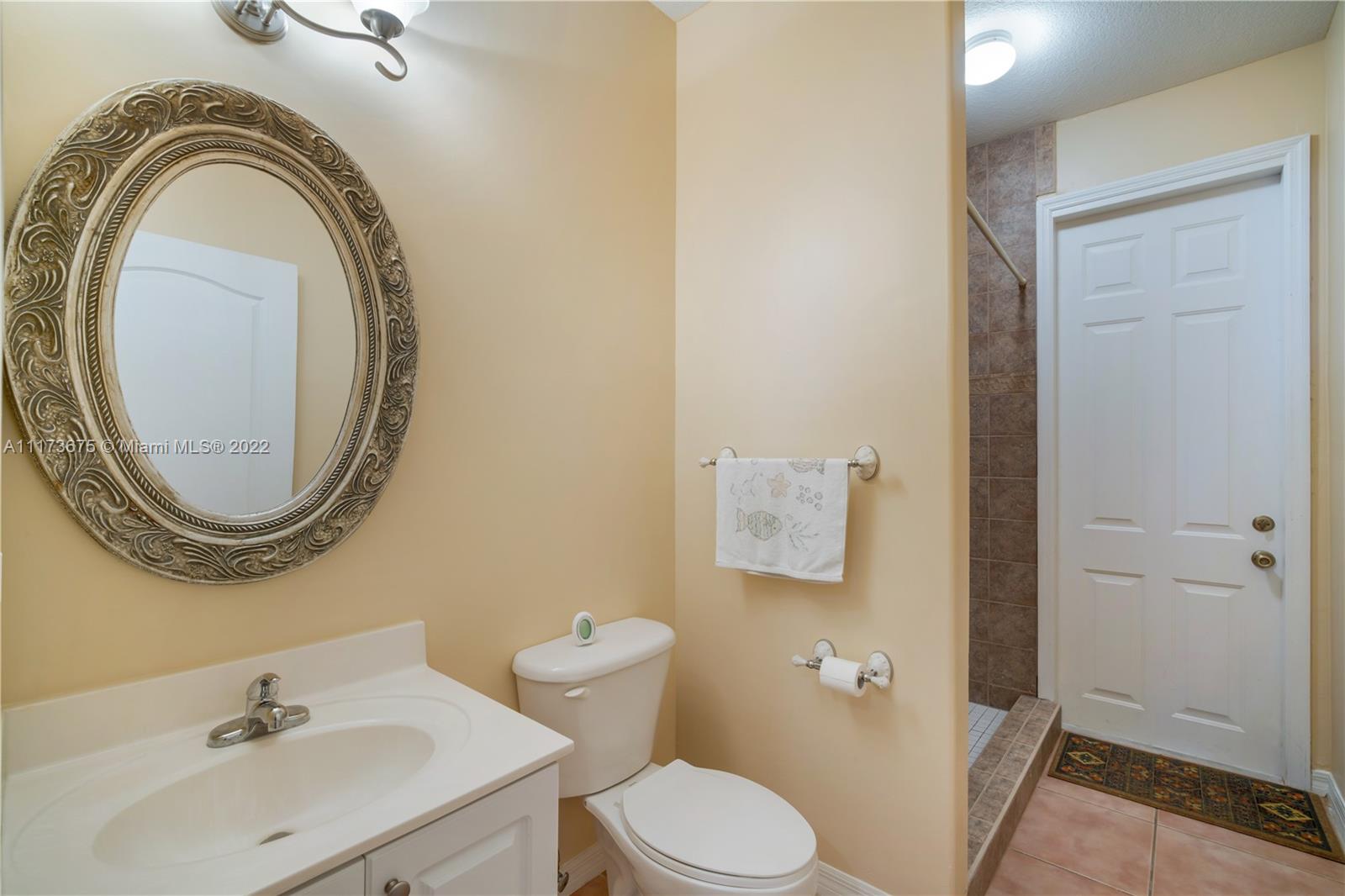 16234 Southwest 48th Terrace Miami, FL 33185 - Photo 23 of 45 a bathroom with a sink a toilet and a mirror