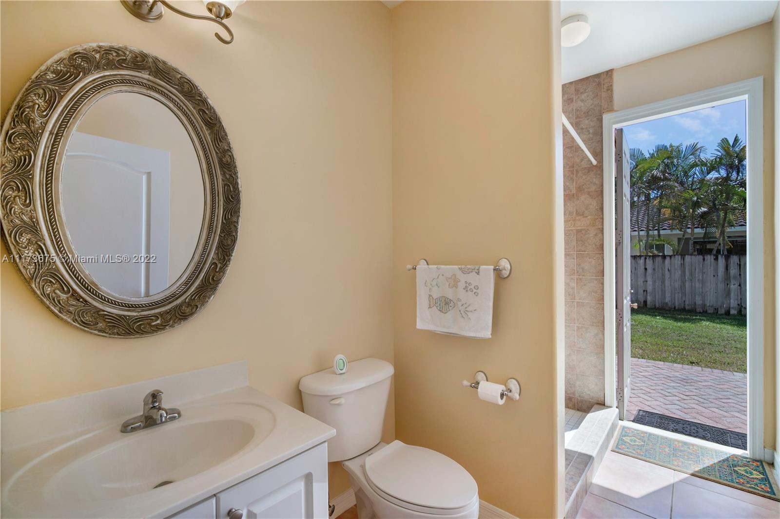 16234 Southwest 48th Terrace Miami, FL 33185 - Photo 24 of 45 a bathroom with a toilet a sink and a mirror