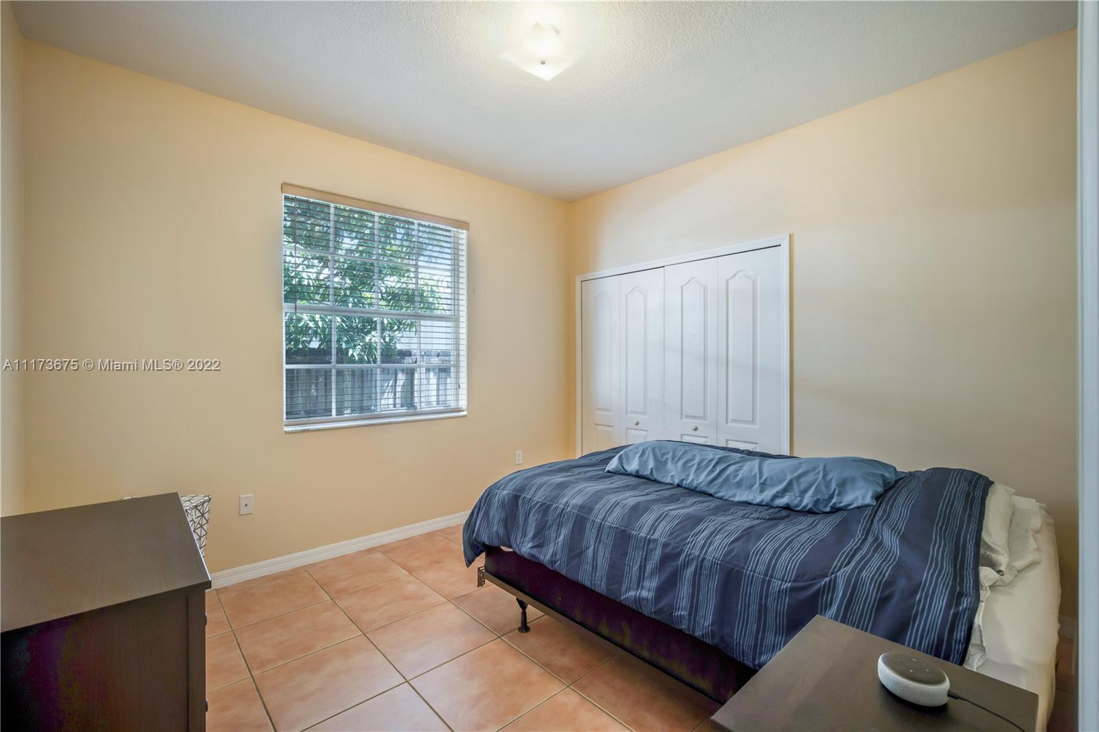 16234 Southwest 48th Terrace Miami, FL 33185 - Photo 26 of 45 a bedroom with a bed and window