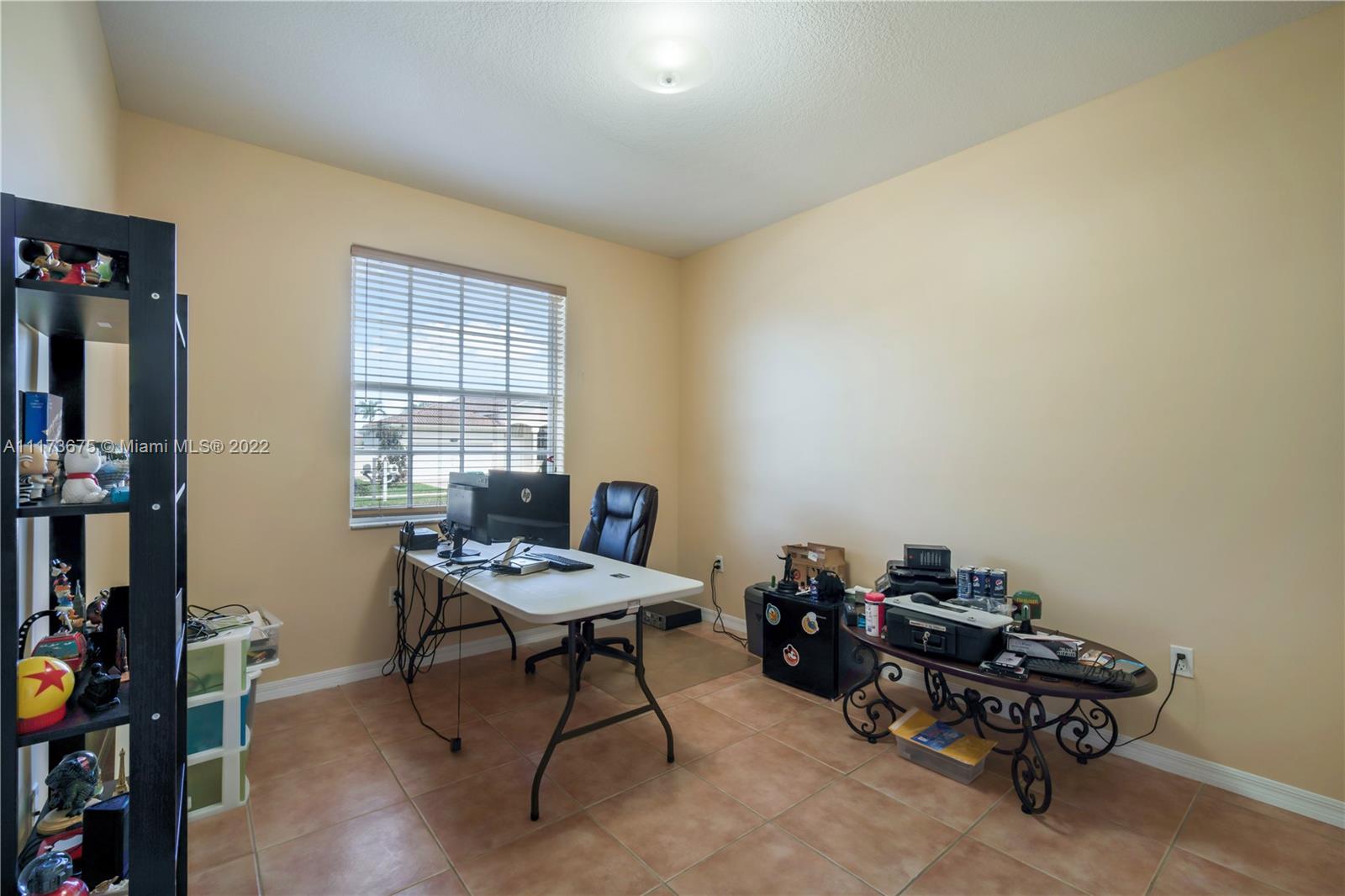 16234 Southwest 48th Terrace Miami, FL 33185 - Photo 29 of 45 a view of a workspace with furniture and a window