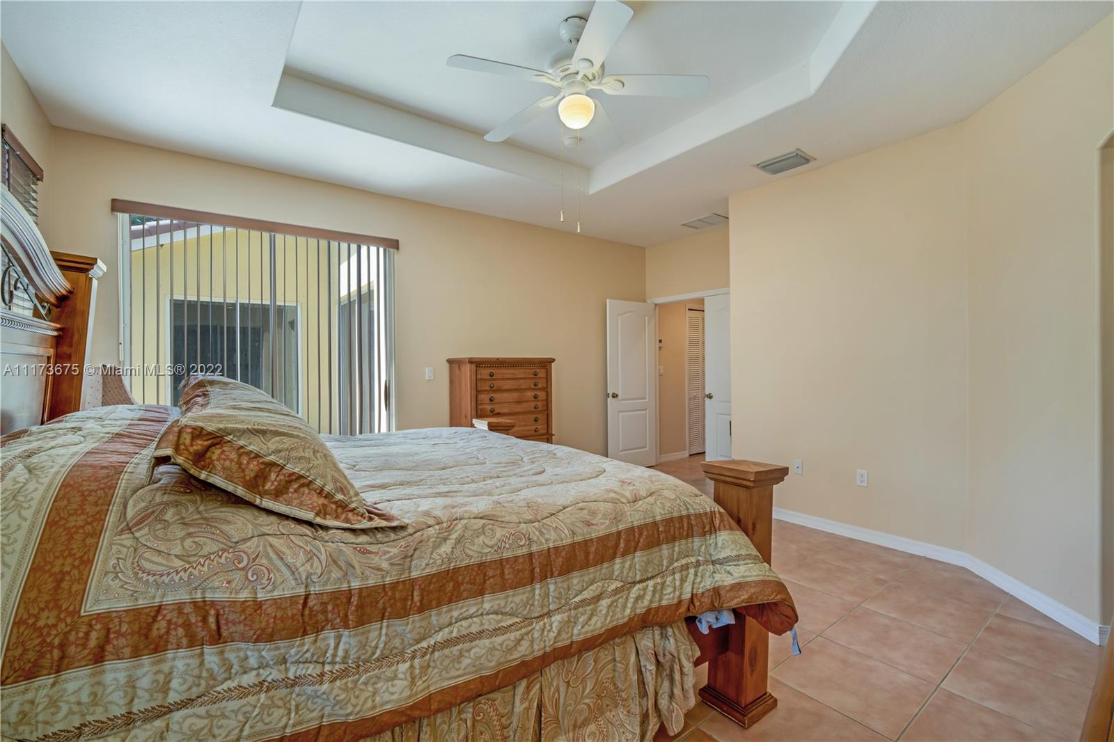 16234 Southwest 48th Terrace Miami, FL 33185 - Photo 32 of 45 a bedroom with a bed and a chandelier