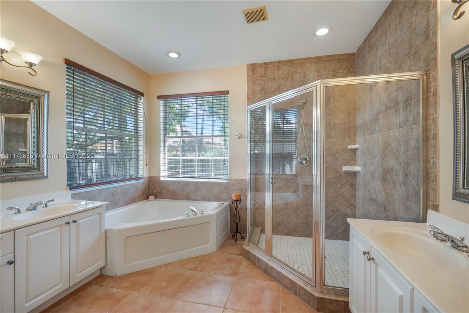 16234 Southwest 48th Terrace Miami, FL 33185 - Photo 34 of 45 a bathroom with a tub sink shower and mirror