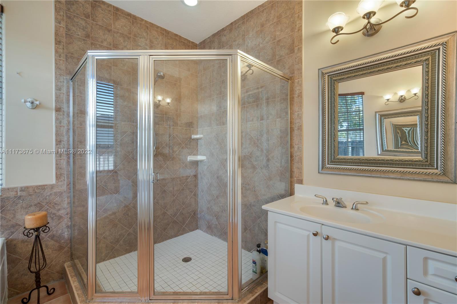 16234 Southwest 48th Terrace Miami, FL 33185 - Photo 36 of 45 a bathroom with a shower sink and mirror