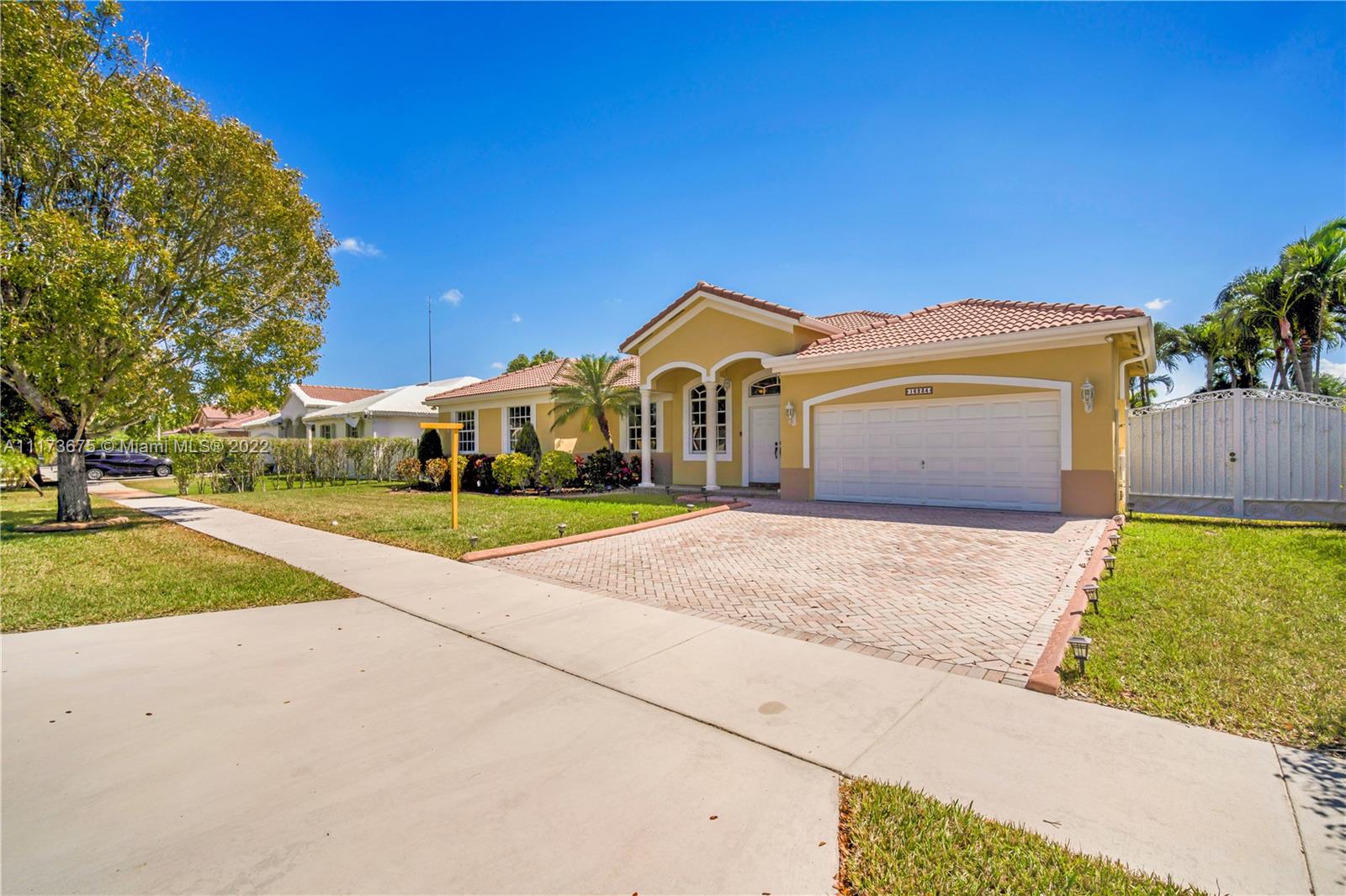 16234 Southwest 48th Terrace Miami, FL 33185 - Photo 4 of 45 a front view of a house with a yard and garage