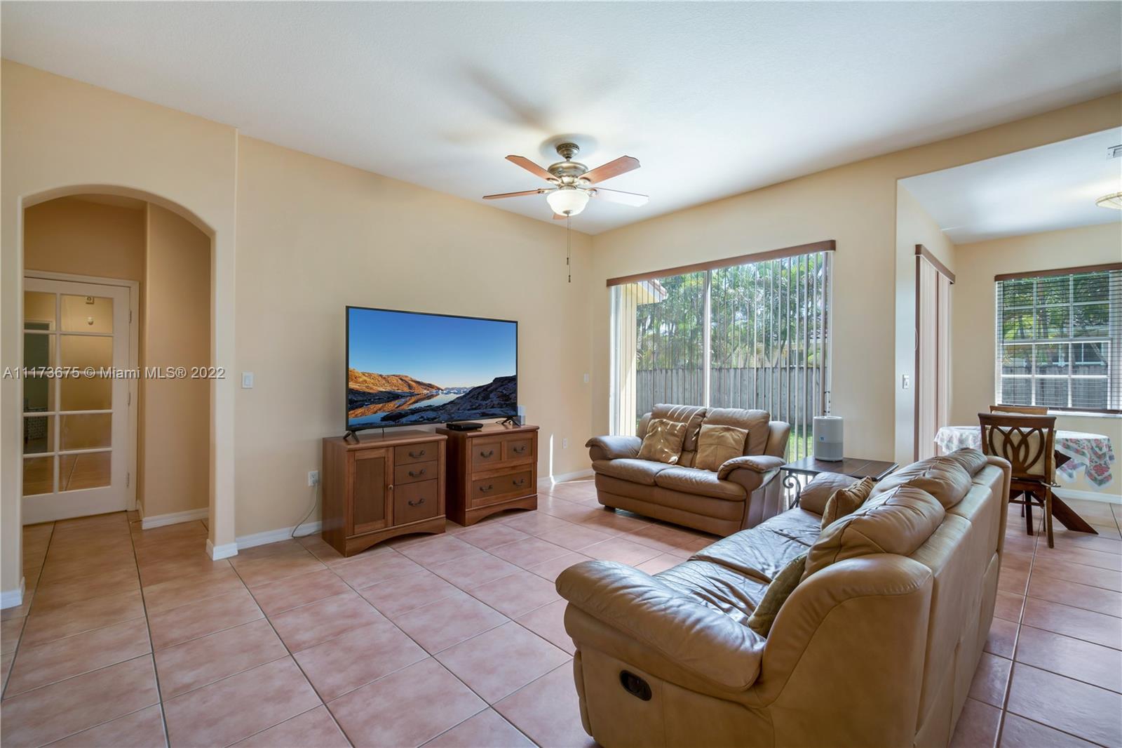 16234 Southwest 48th Terrace Miami, FL 33185 - Photo 7 of 45 a living room with furniture a ceiling fan and a window