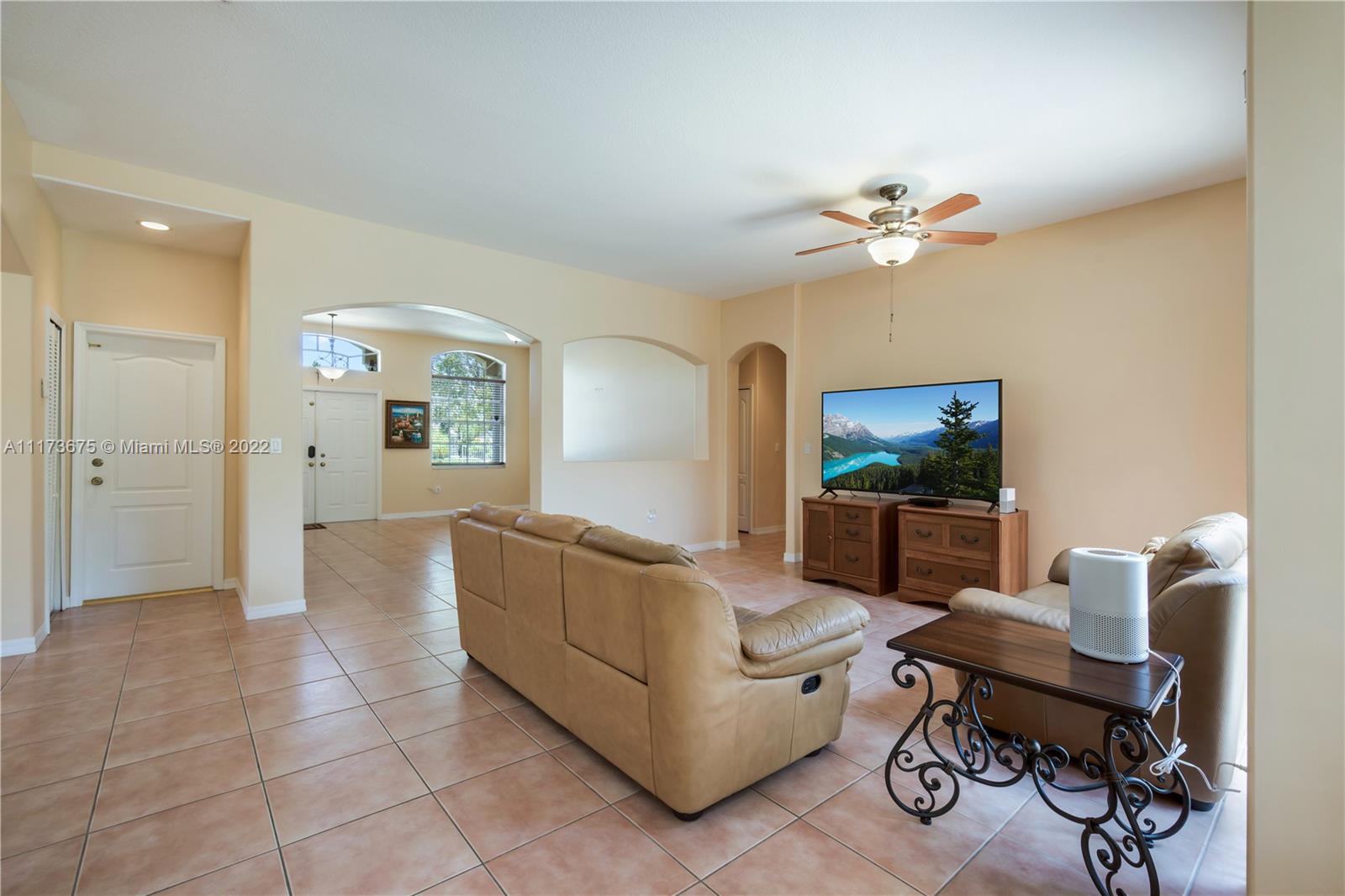 16234 Southwest 48th Terrace Miami, FL 33185 - Photo 8 of 45 a living room with furniture a ceiling fan a rug and a window