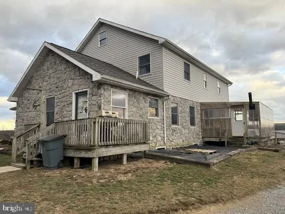 a view of a house with a yard covered in snow