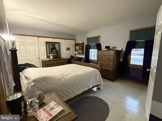 a bedroom with bed and window