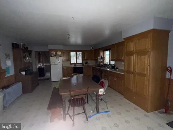 a kitchen with sink cabinets and stove top oven
