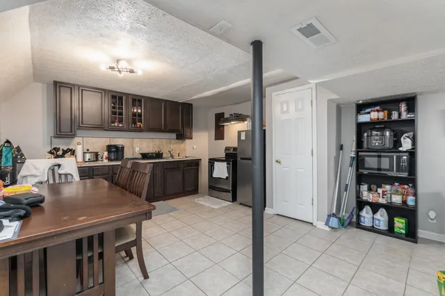 a kitchen with refrigerator cabinets and a sink