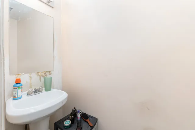 a bathroom with a sink a toilet and a mirror