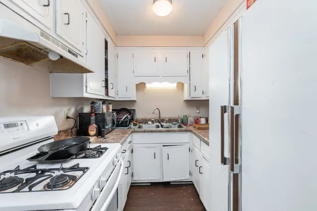 a kitchen with a sink stove and cabinets