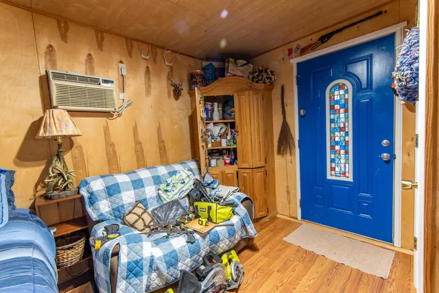 a bedroom with bed and wooden floor