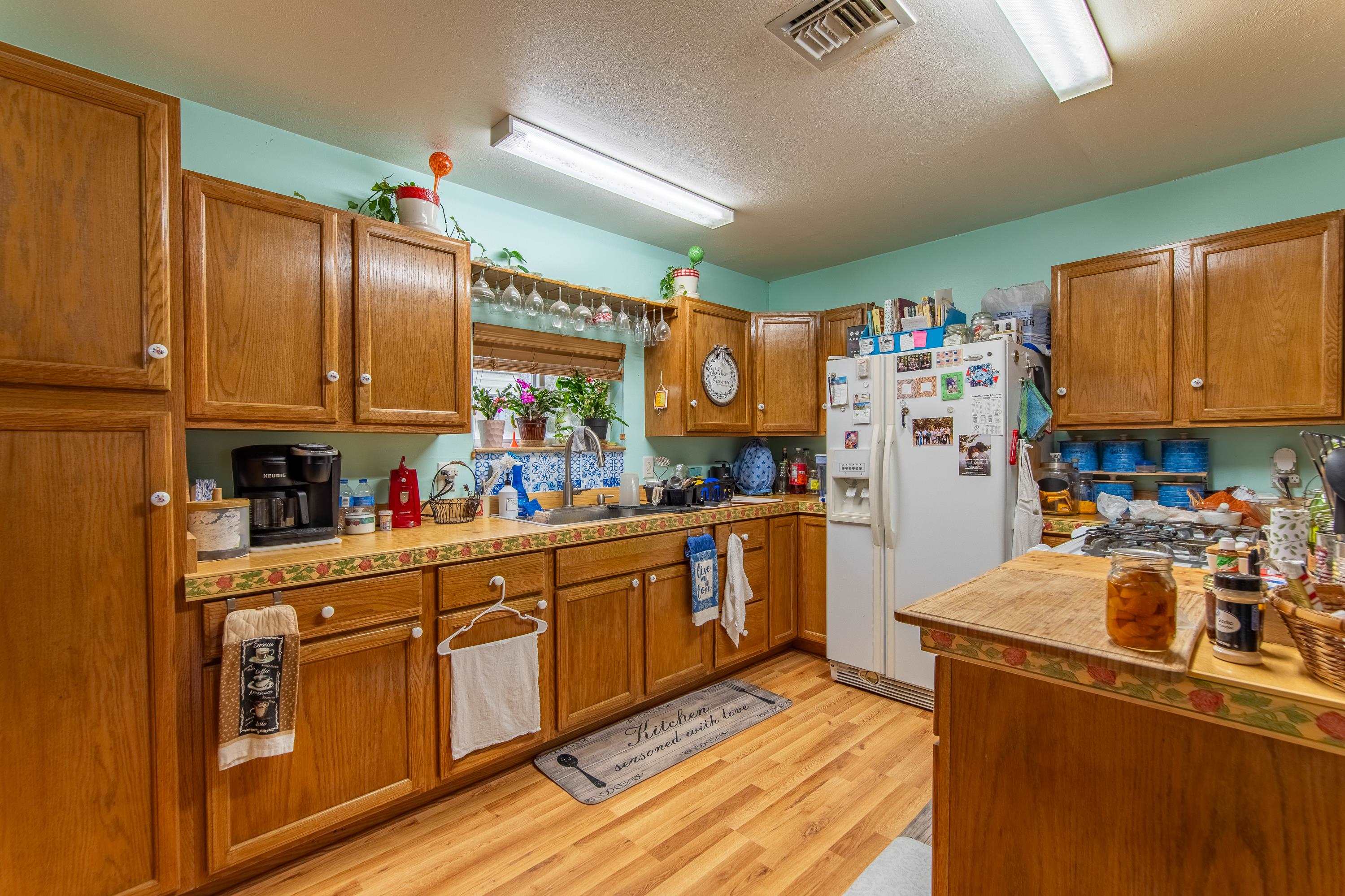 2040 Liberty Road Morris Chapel, TN 38361 - Photo 2 of 40 a kitchen with stainless steel appliances granite countertop a refrigerator a sink dishwasher stove and oven with wooden cabinets