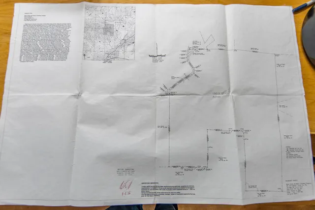 a view of a yard with wooden fence