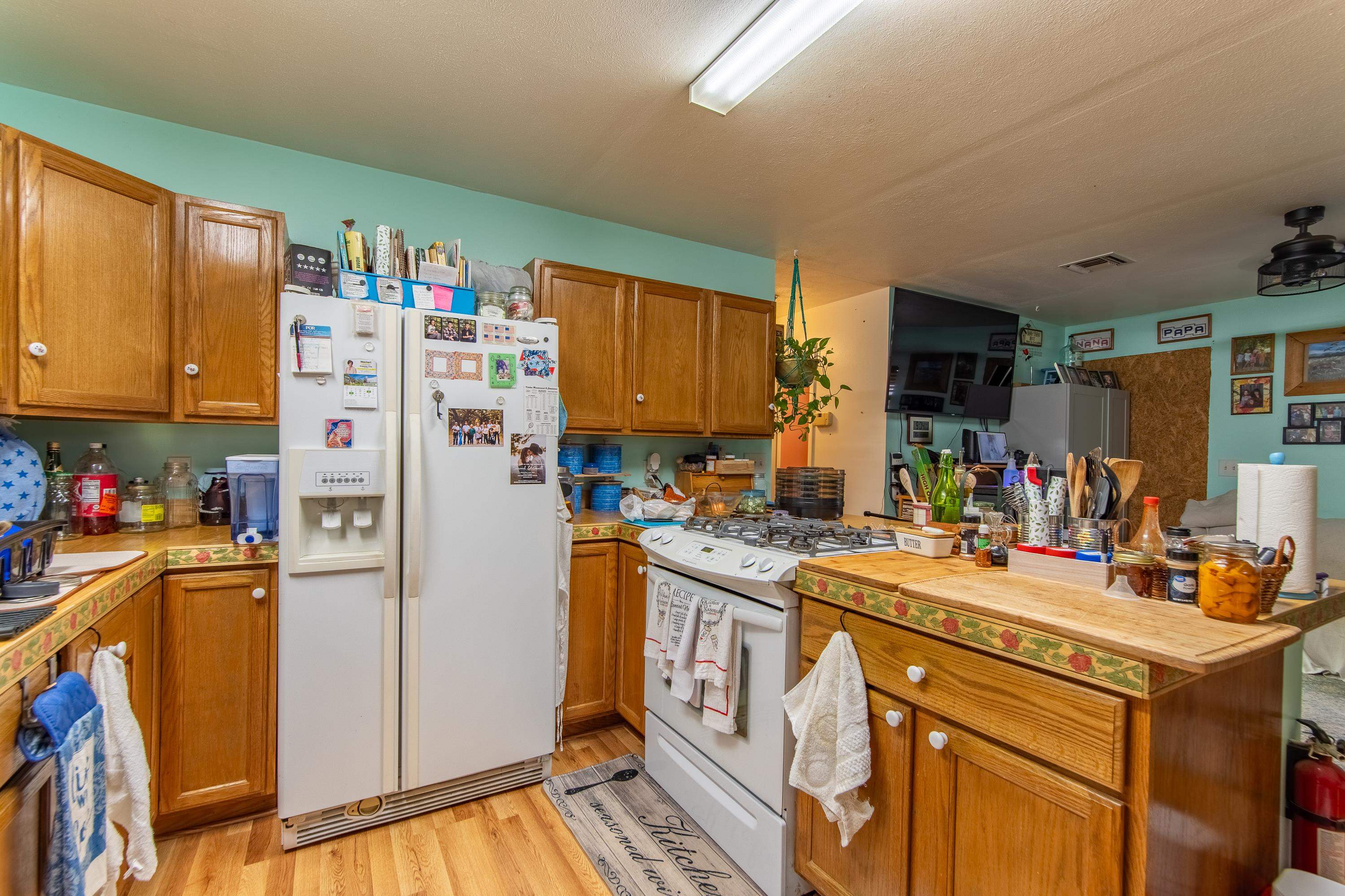2040 Liberty Road Morris Chapel, TN 38361 - Photo 3 of 40 a kitchen with a refrigerator a stove a sink dishwasher and wooden cabinets with wooden floor