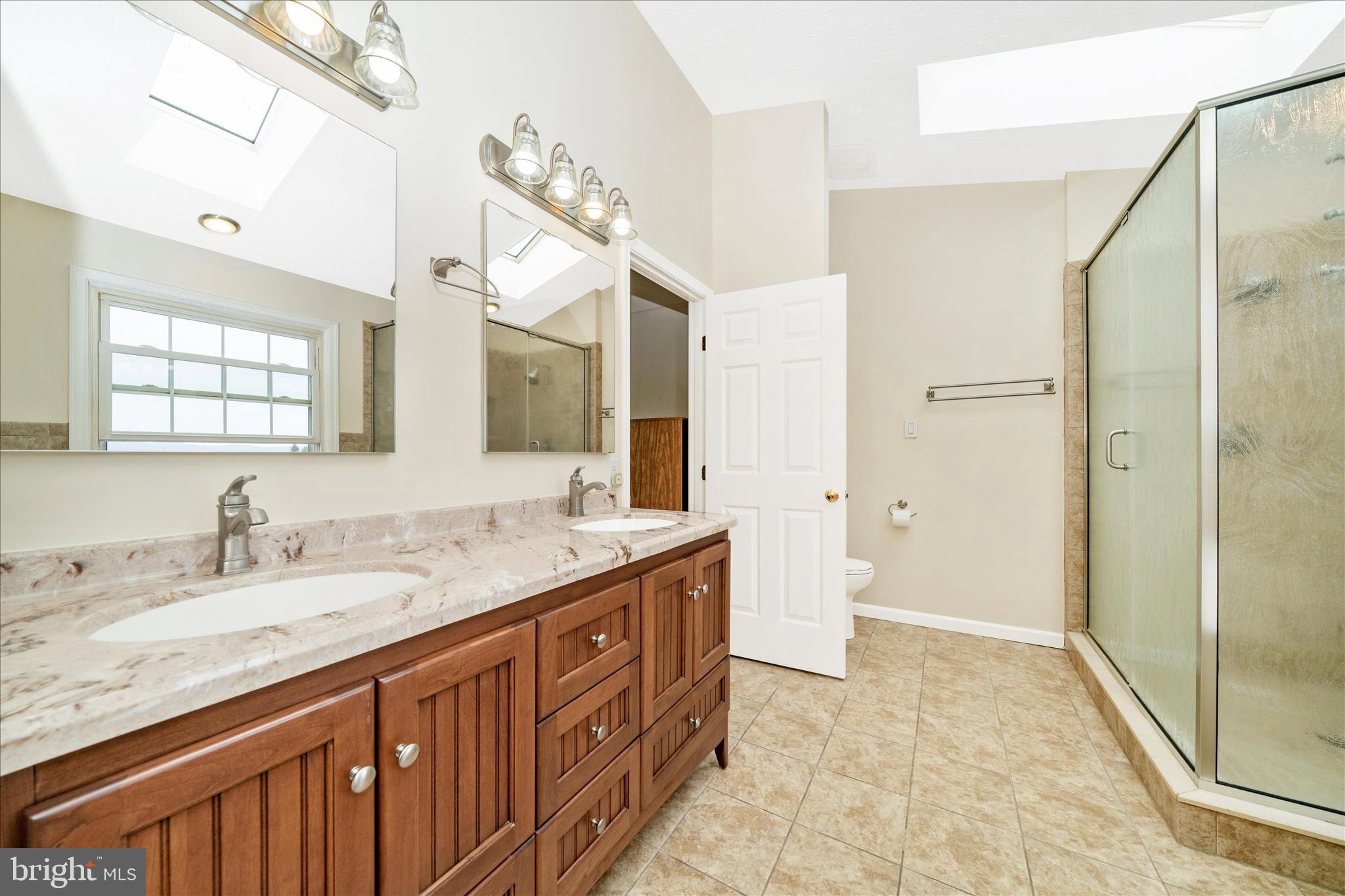 9534 Liberty Road Frederick, MD 21701 - Photo 32 of 70 a bathroom with a granite countertop sink and a mirror
