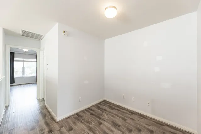 a view of hallway with wooden floor