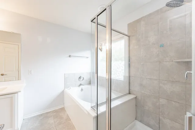 a bathroom with a bathtub and a shower