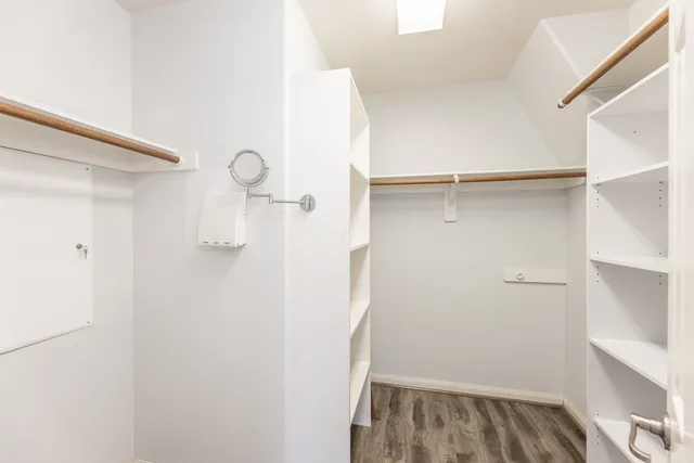 a view of walk in closet with empty racks